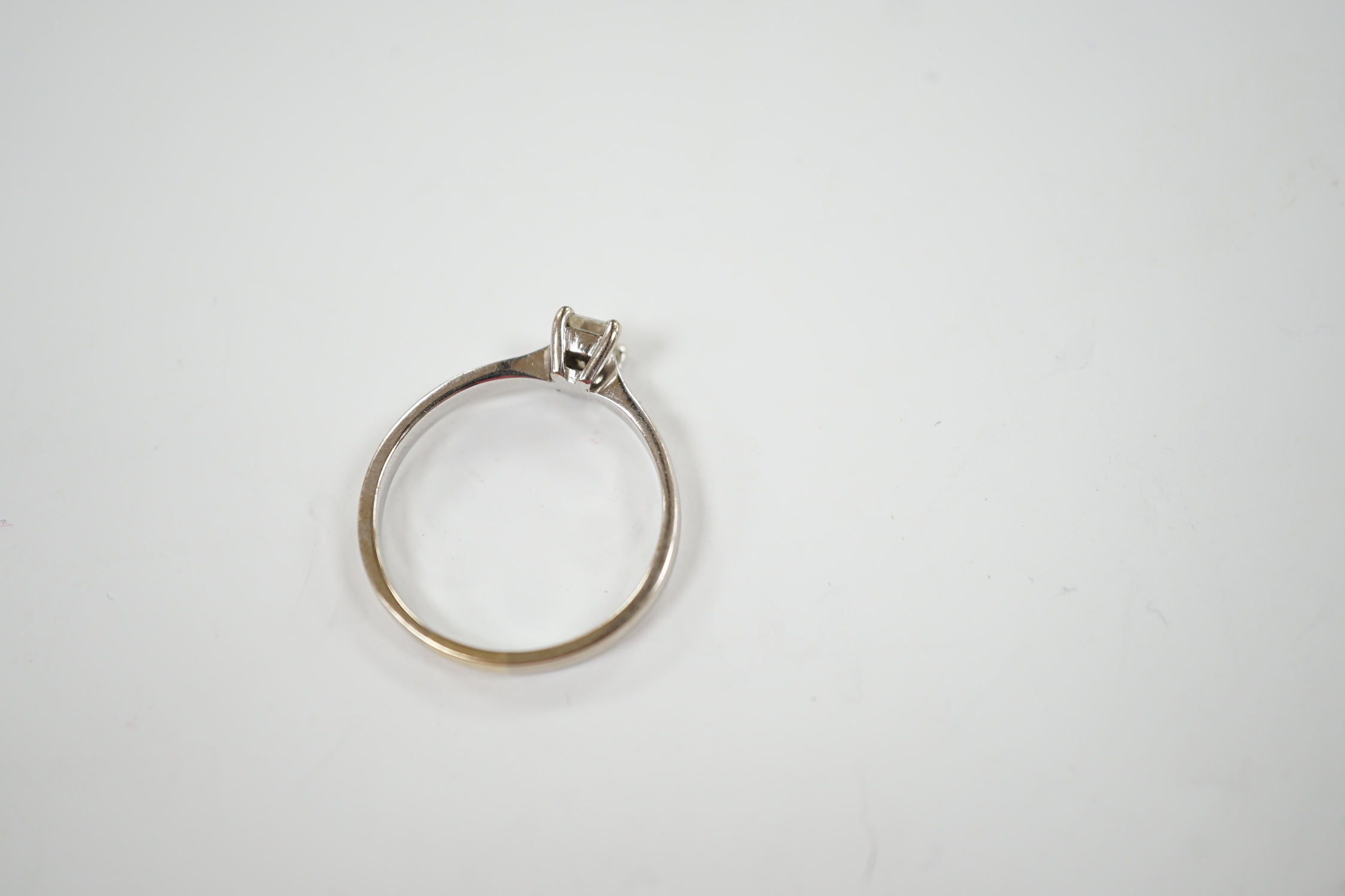 A modern 18ct white gold and solitaire emerald cut diamond set ring, size Q, gross weight 3.4 grams.